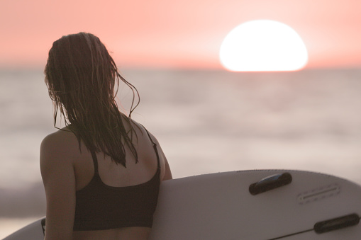 Woman at Beach after Surfing in Costa Rica at Sunset