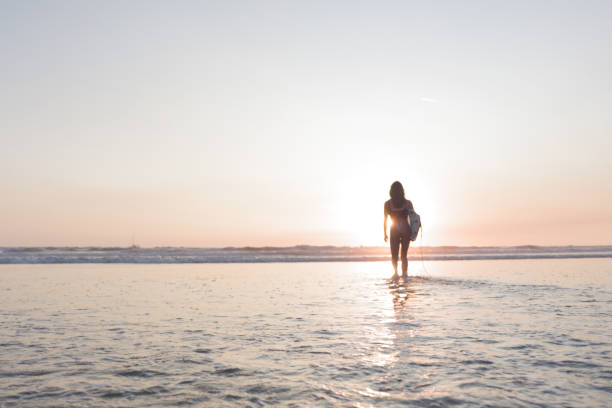 istock Woman Going for a Surf in Costa Rica 1409530898