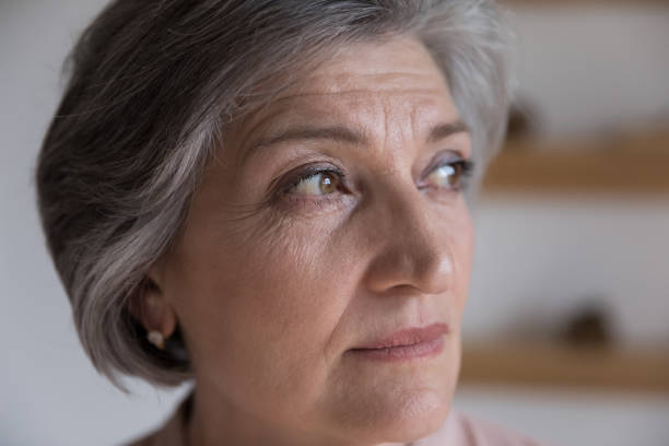 istock Serious thoughtful senior mature woman looking away in deep thought 1409531398