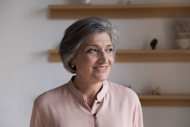 istock Positive thoughtful senior grey haired lady looking away 1409531399