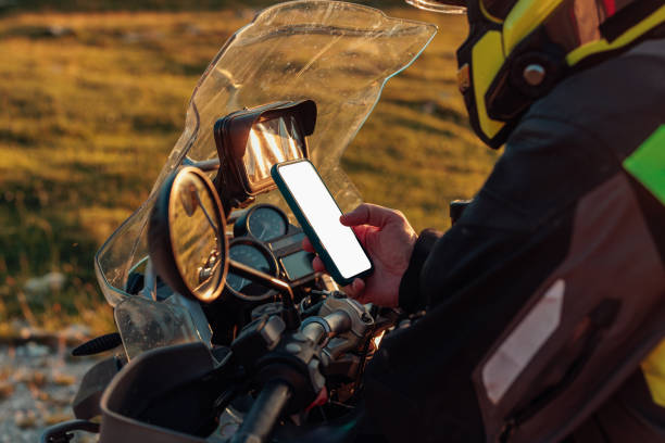 istock Motorcyclist holding his phone and searching for direction 1409532458