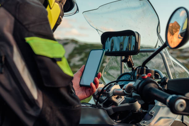 istock Motorcyclist holding his phone and searching for direction 1409532807