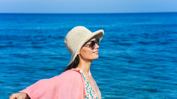 istock woman in hat on the beach 1409533685