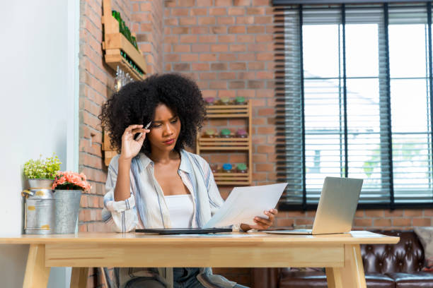 istock Business woman using digital table and working on laptop computer in modern home office. 1409533977