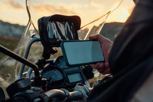 istock Biker holding mobile phone looking for the right route 1409535573