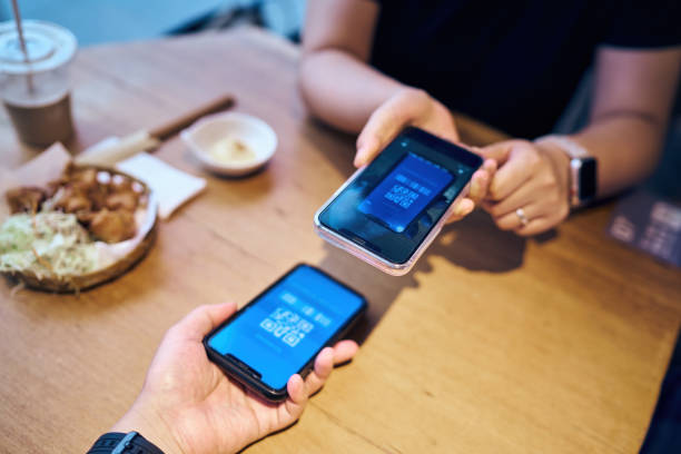istock Close up using mobile phone to pay in restaurant 1409535755