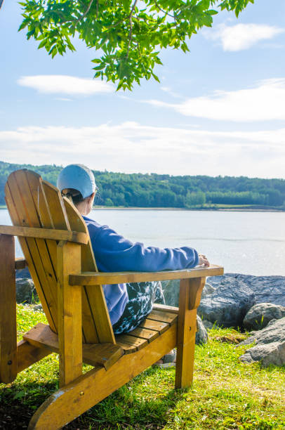 istock Woman in adirondack chair 1409538042