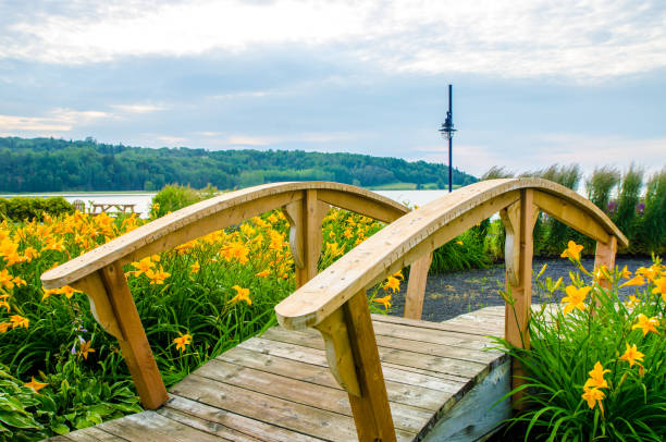 Decorative bridge in front of St. Lawrence river at the public park Quai Casgrain in La Malbaie during summer day