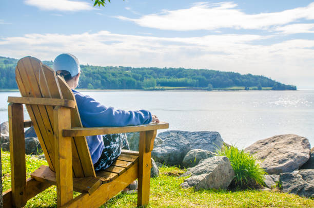 istock Woman in adirondack chair 1409538236