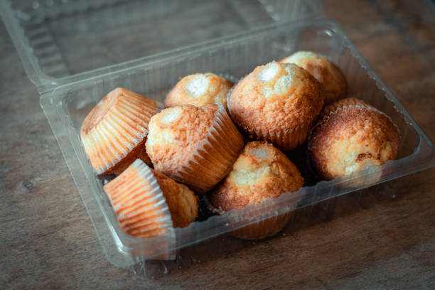 istock Homemade cupcakes plastic container wooden background 1409544524