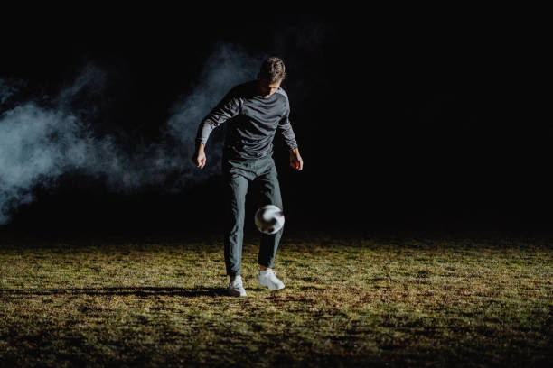istock Young man juggles a soccer ball on his leg 1409545869