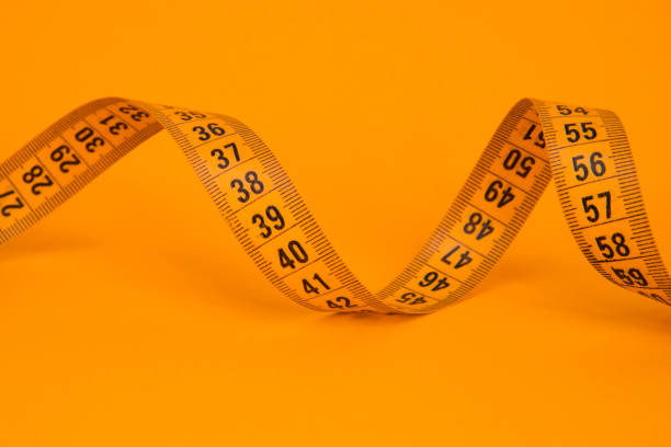 istock Spiral tape measure colorful background with copyspace 1409548895