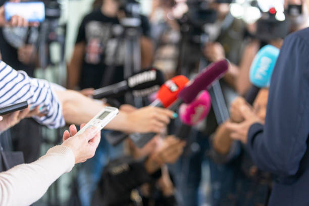 Reporters at press conference holding microphone making media interview with unrecognizable politician or business person Journalists at news conference holding microphone making media interview with unrecognizable politician or business person spokesperson stock pictures, royalty-free photos & images