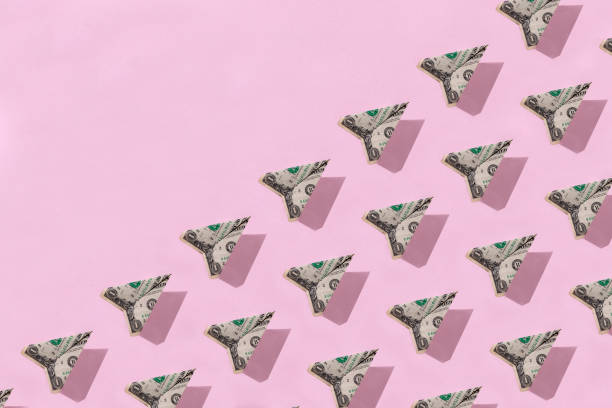 istock Money Plane On Pink Background. 1409550243
