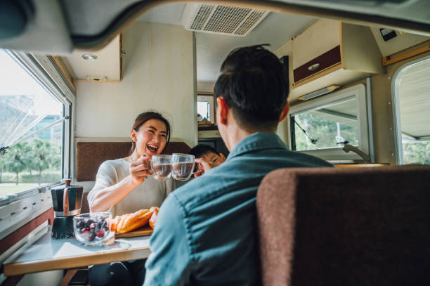 istock Asian parents and their kid enjoy breakfast with their camper van 1409550941