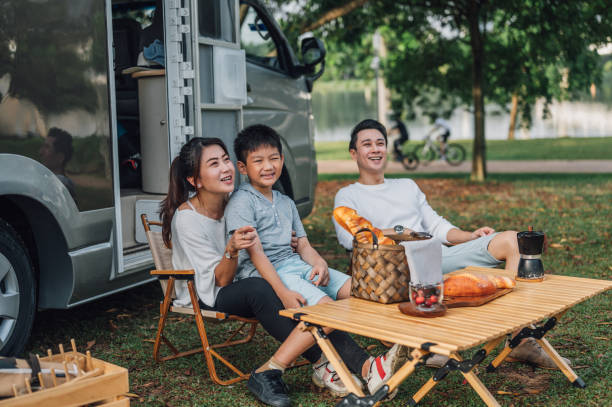 istock Happy Asian parents and their kid communicating while spending a spring day on camping 1409551180