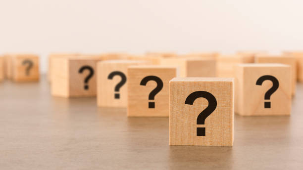 istock front view on many wood cubes with question marks. many question arising concept 1409551297