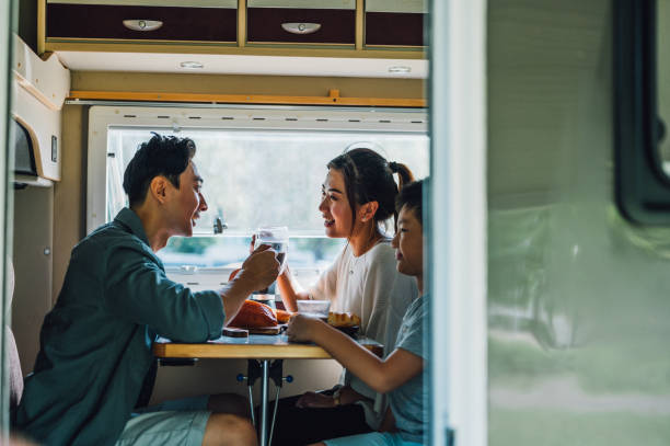 istock Cheerful Asian parents and their kid enjoy breakfast with their camper van 1409552009
