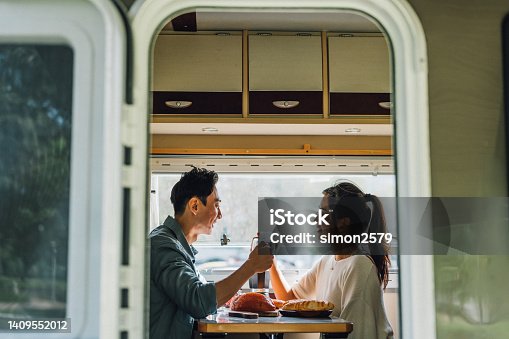 istock Lovely Asian Chinese couple enjoy breakfast with their camper van - Camper van travel series 1409552012