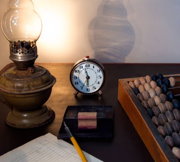 istock Old wooden abacus, kerosene lamp and ink stamp. 1409553631