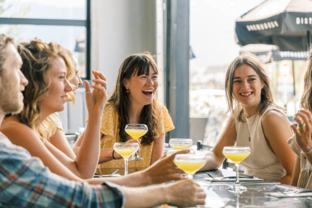 Group of friends enjoy drinks at cocktail bar / Brewery stock photo