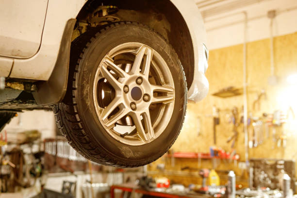 istock Car wheel on a lift in a car service. 1409557556