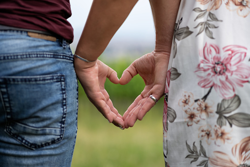 Couple showing a heart with their hands together