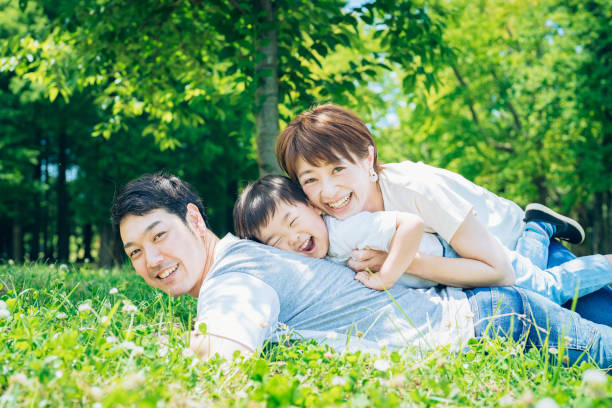 istock Parents and child lying on the meadow 1409559196