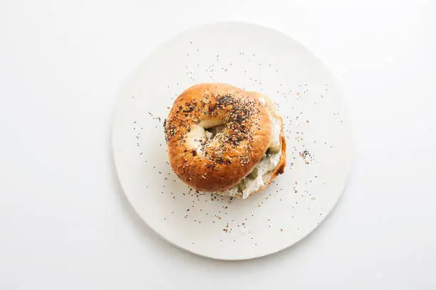 Everything Bagel topped with cream cheese and green olives