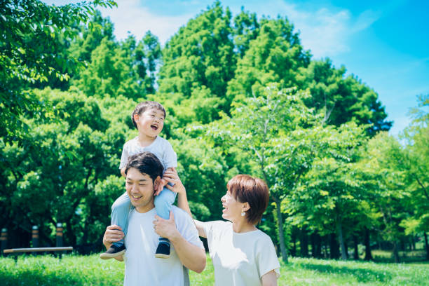 istock Parents and child playing while piggybacking in the park 1409560313