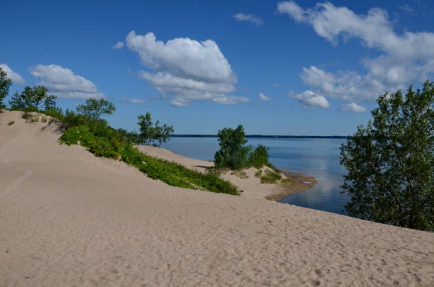 Dunes Beach sand dunes at Sandbanks Provincial Park Dunes Beach sand dunes at Sandbanks Provincial Park in Ontario, Canada.   Sandbanks is the largest baymouth barrier dune formation in the world. It is located on Lake Ontario. sandbanks ontario stock pictures, royalty-free photos & images