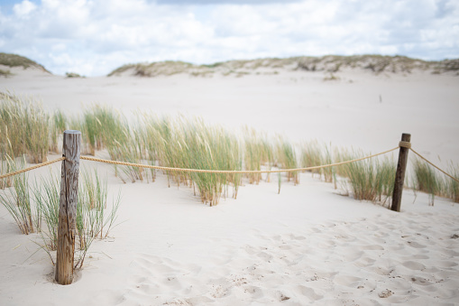 Slufter valley at the beach of Texel island in the Dutch Wadden Sea region during a sunny but stormy autumn afternoon at the North Sea beach.