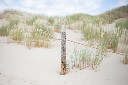 Dunes in the Słowiński National Park. Northern Poland. Baltic Sea. Path in the Dunes. Pole with a rope.