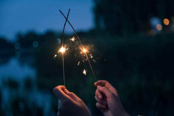 Asian girls playing fireworks at night