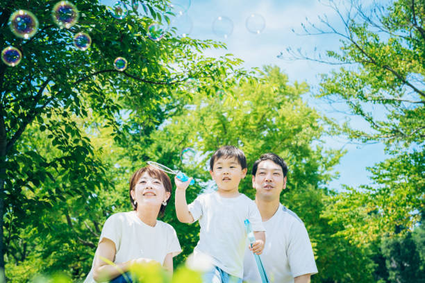 istock Parents and their child playing with soap bubbles 1409564457