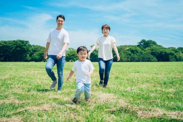 istock Parents and their child running around the meadow 1409564786