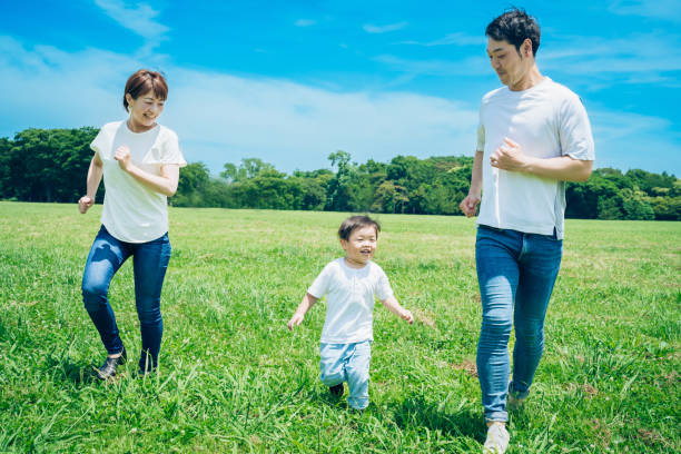 istock Parents and their child running around the meadow 1409564858