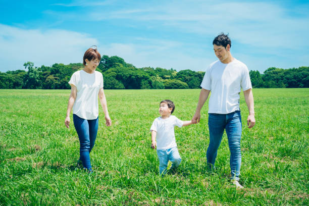 istock Parents and their child running around the meadow 1409564914