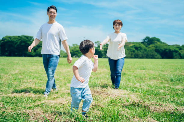 istock Parents and their child running around the meadow 1409565127