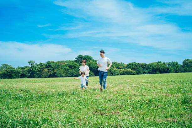 istock Parents and their child running around the meadow 1409565349