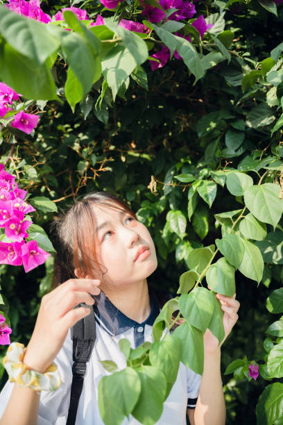 istock Asian girls in flowers 1409566401