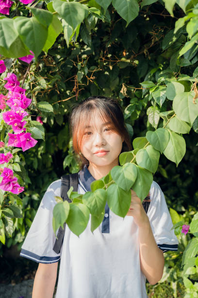 istock Asian girls in flowers 1409566407