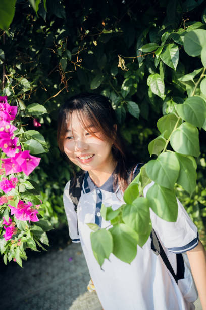 istock Asian girls in flowers 1409566412