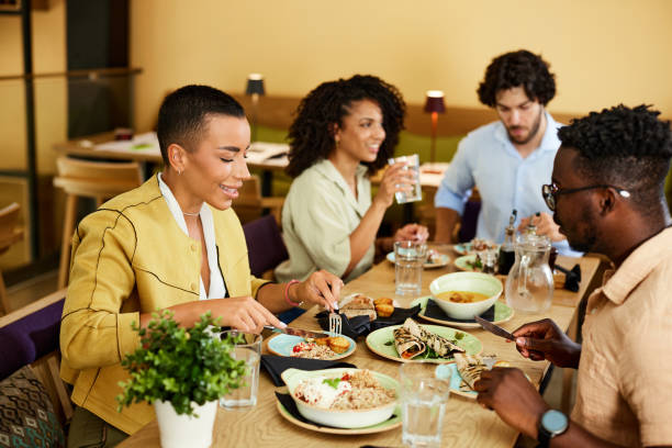 istock Hungry friends sit in a restaurant and eat dinner. 1409566674