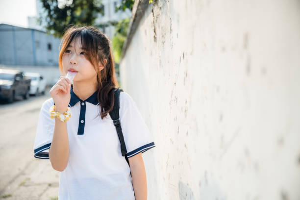 istock Asian girls eating ice cream 1409568046
