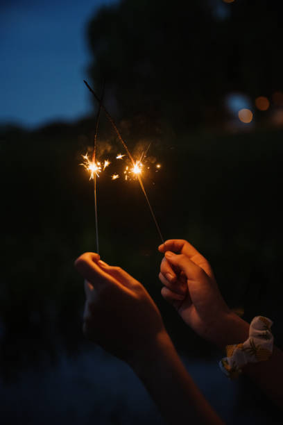 istock Asian girls playing fireworks at night 1409568140