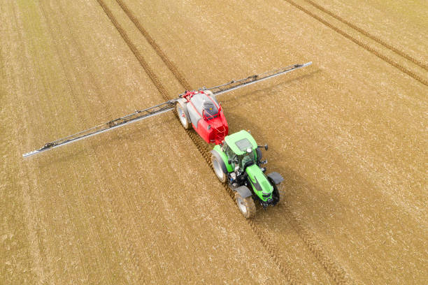 istock Tractor Spraying Field for Next Crops, Aerial View 1409570534