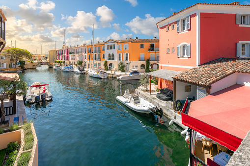 Luxury waterfront homes with boat docks on Venetian style canals in the residential planned community of Port Grimaud, near the village of Grimaud and close to Saint-Tropez along the French Riviera, Cote d'Azur.