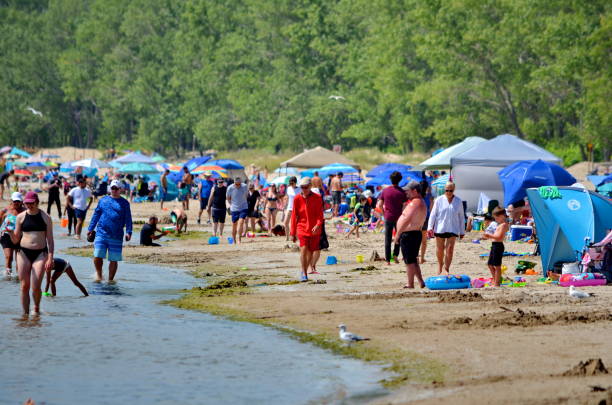People enjoy the Outlet beach at Sandbanks Provincial Park Prince Edward County, Ontario, Canada, July 14, 2022: People enjoy the Outlet beach at Sandbanks Provincial Park. Sandbanks is located on the north-east side of Lake Ontario. sandbanks ontario stock pictures, royalty-free photos & images