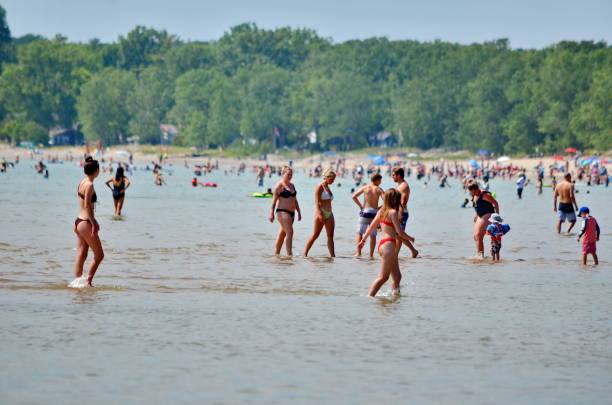 People enjoy the Outlet beach at Sandbanks Provincial Park Prince Edward County, Ontario, Canada, July 14, 2022: People enjoy the Outlet beach at Sandbanks Provincial Park. Sandbanks is located on the north-east side of Lake Ontario. sandbanks ontario stock pictures, royalty-free photos & images